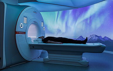 A person lying in a machine.