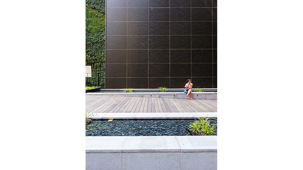 A person sitting on a ledge.