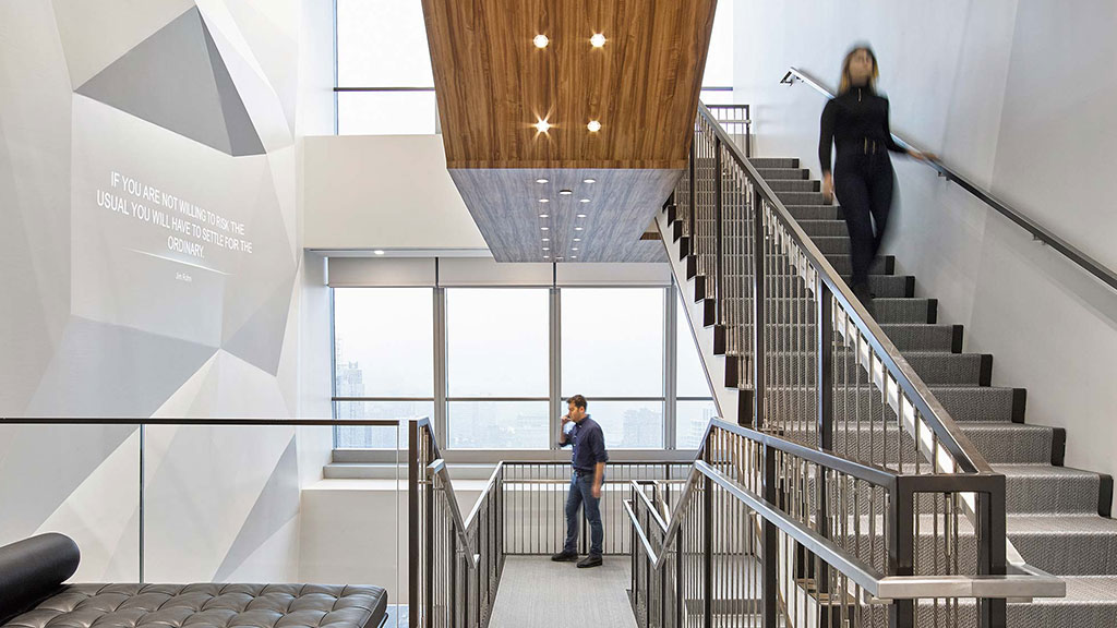A man and woman walking up a flight of stairs.