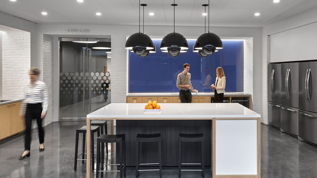 A group of people in a kitchen.