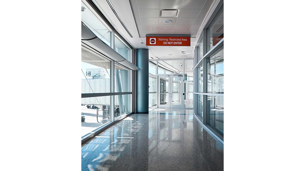 A large glass building with a sign.