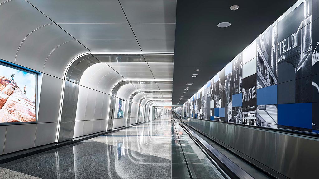 A long hallway with a few people.