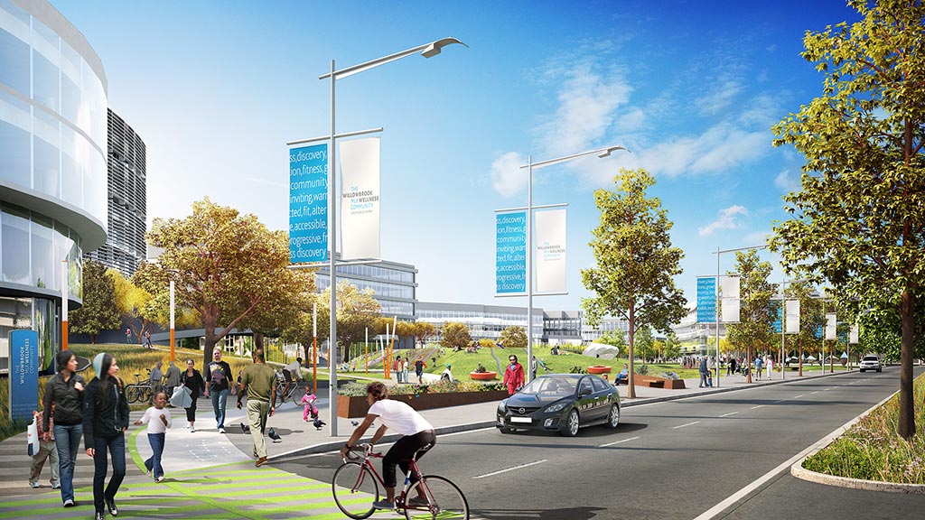 A person riding a bicycle on a street with people walking around.