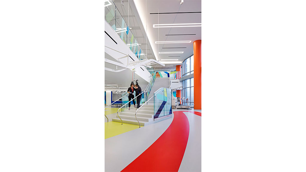 A couple of people walking down a flight of stairs.