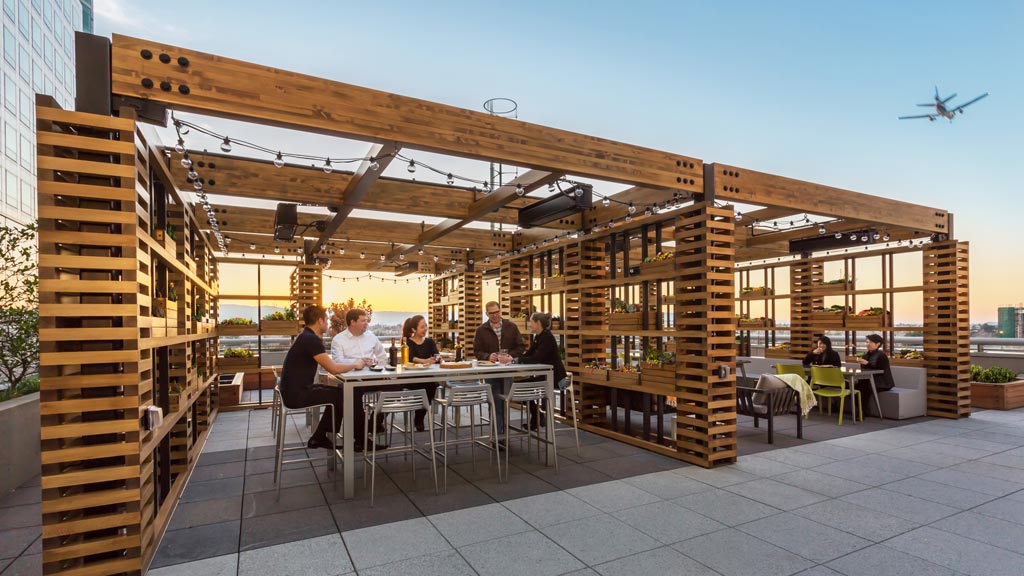 A group of people sitting at a table outside.