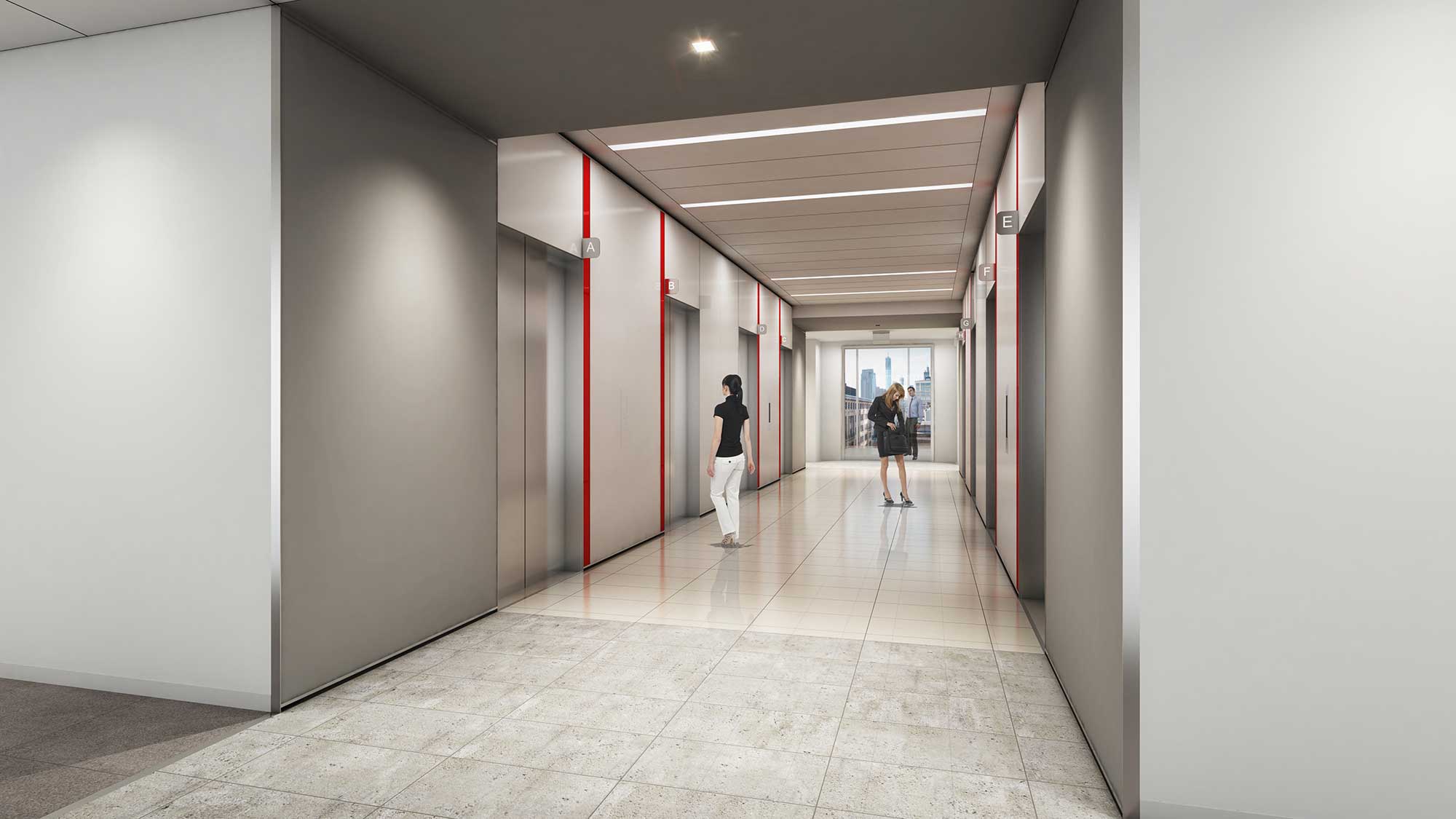 A couple of people walking through a hallway.