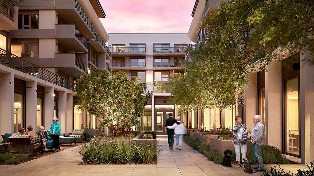 A group of people walking outside of a building.