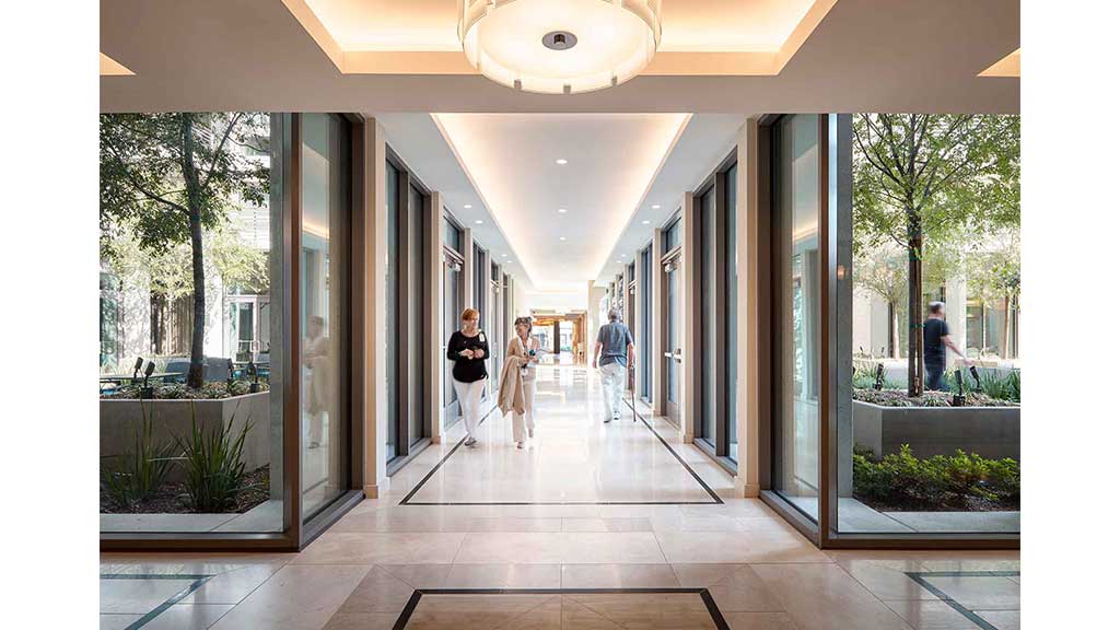 A group of people walking through a building.