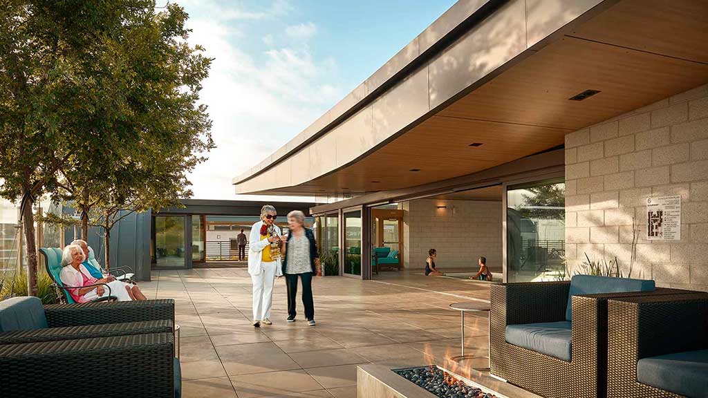 A couple of people walking outside a building.