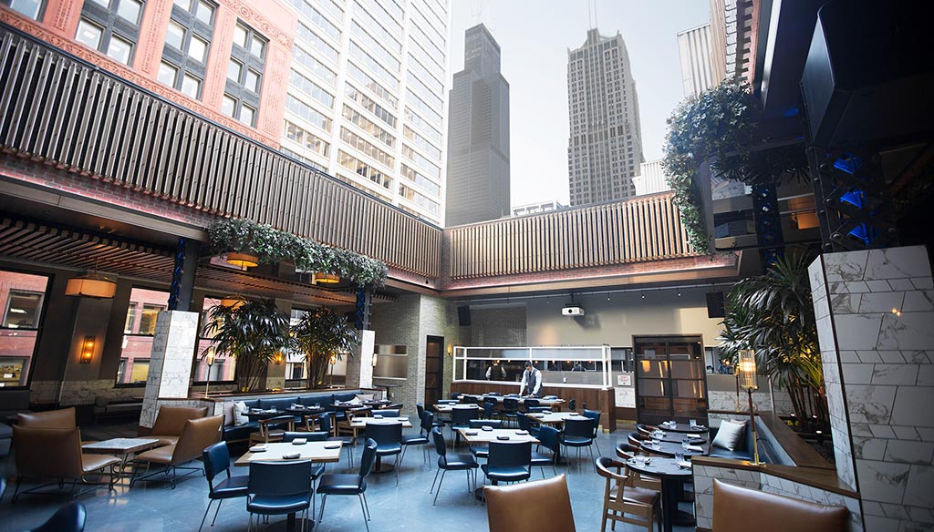 A courtyard with tables and chairs.