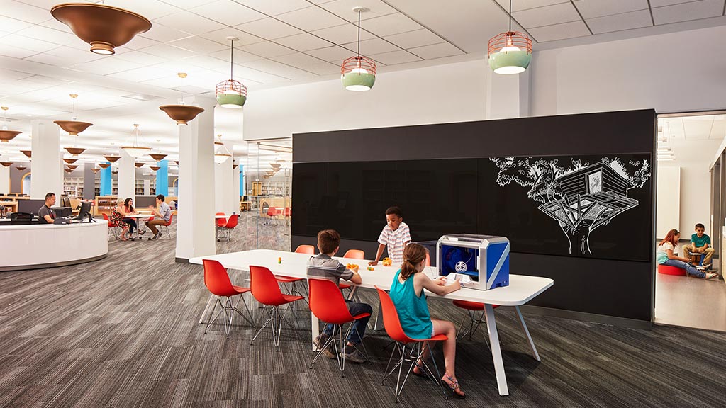 A group of people sitting at tables.