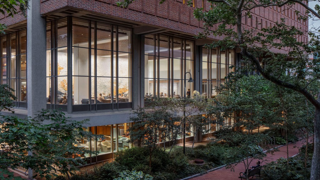 A building with trees and plants in front of it.