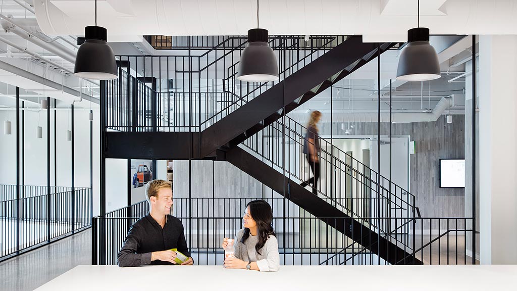 A man and woman sitting on a staircase.