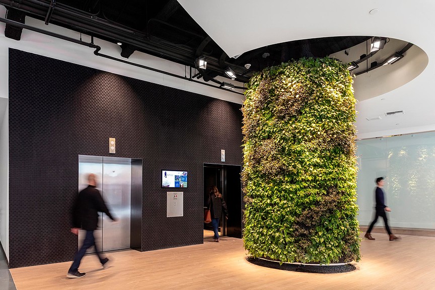 A group of people walking through a building.