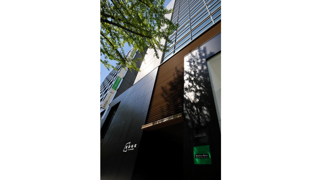 A tall building with a tree in the front.