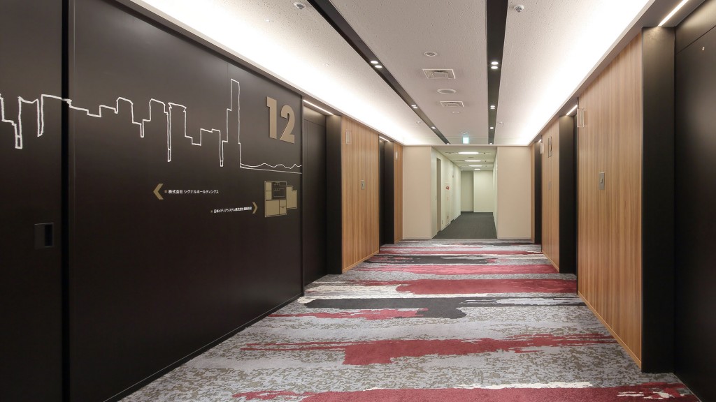 A hallway with a red carpet.