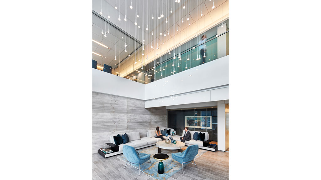 A room with a glass ceiling and a couple of people sitting in chairs.