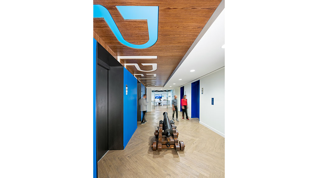 People with luggage in a hallway.