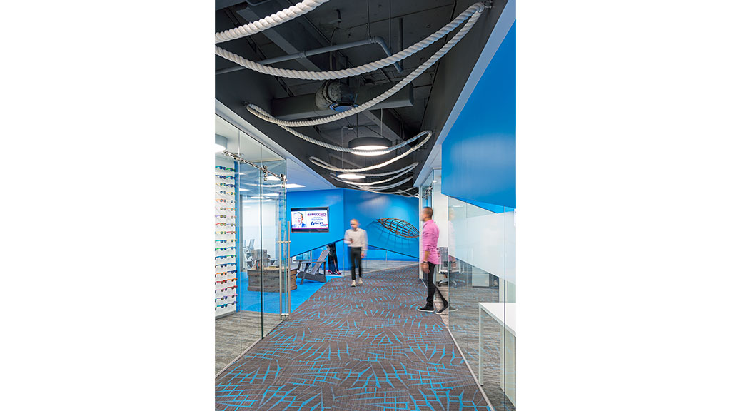 A couple of men standing in a large room with a large ceiling.