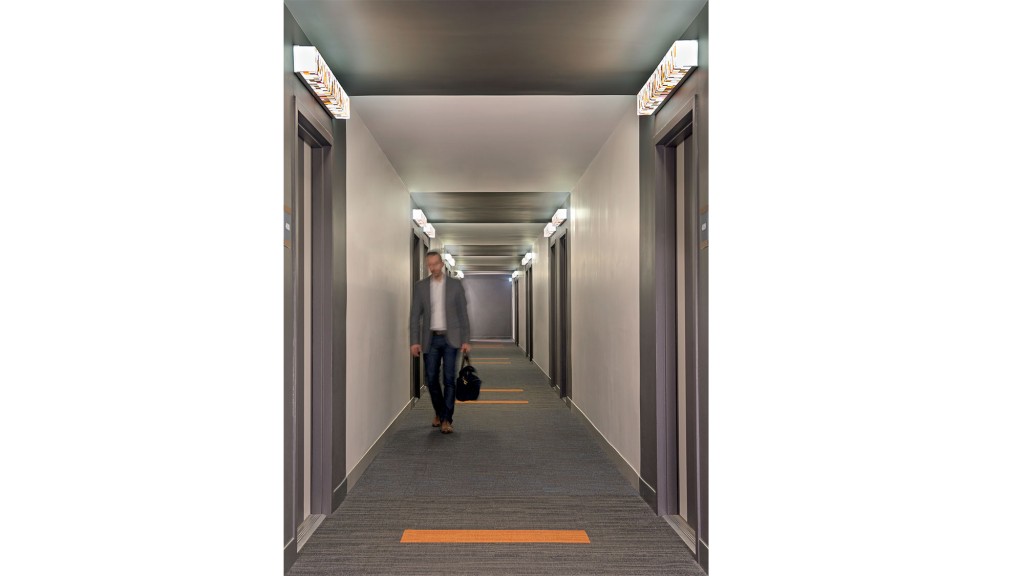 A person walking down a hallway.