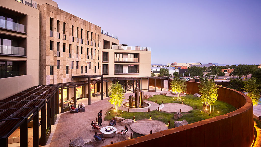 A courtyard with a fountain and buildings.
