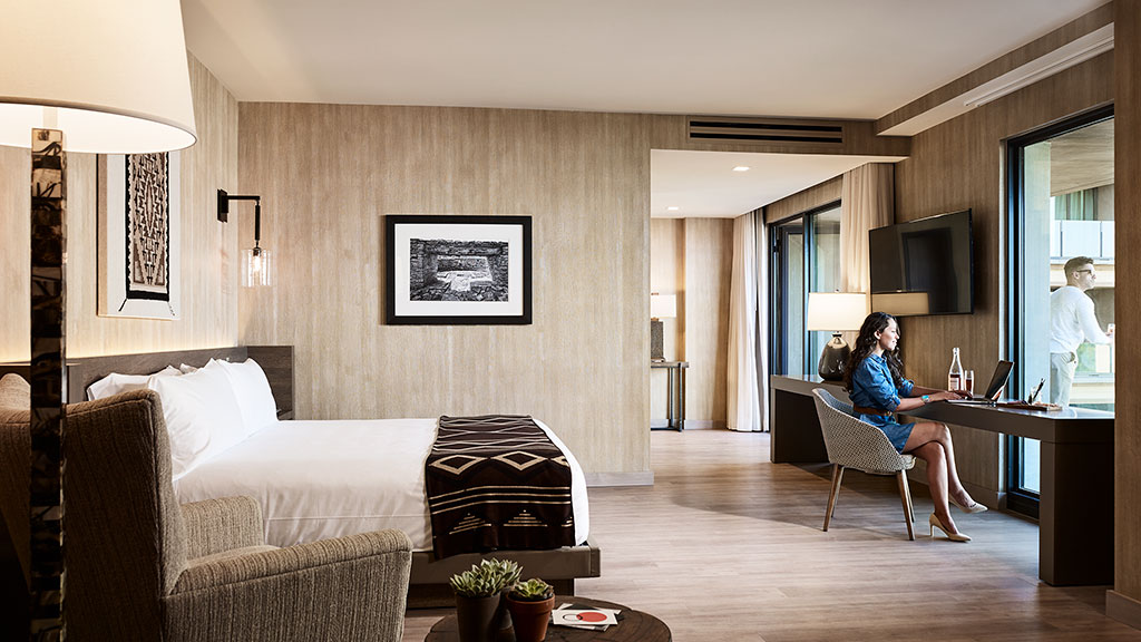 A couple of women sit in a living room.