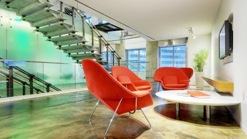 A room with red chairs and a table.