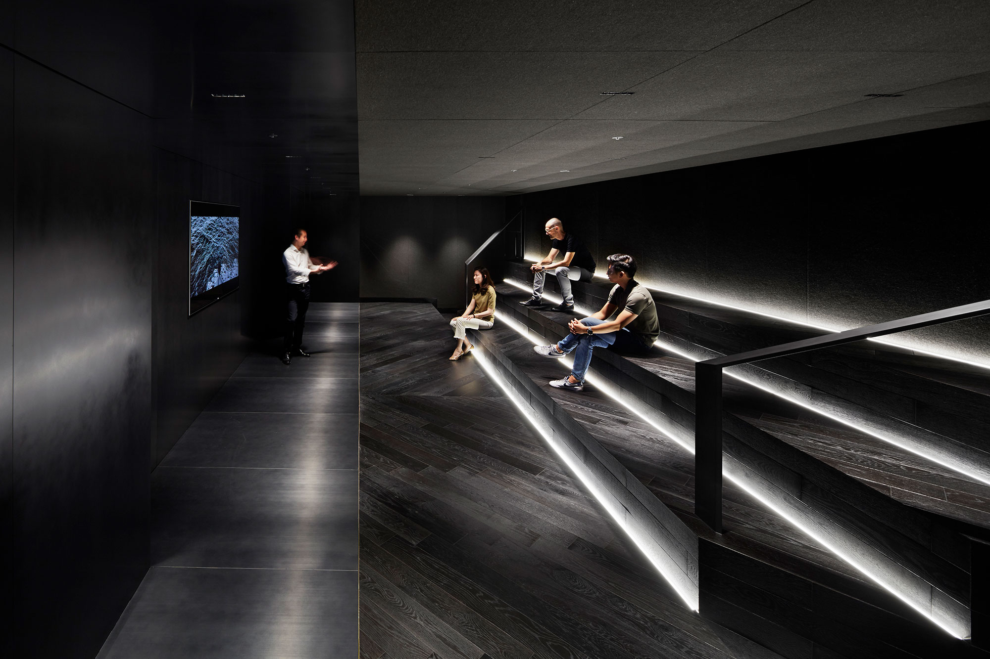 A group of people sitting on a staircase.