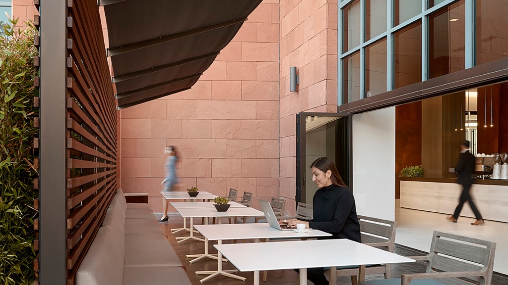 A man sitting at a table with a laptop.