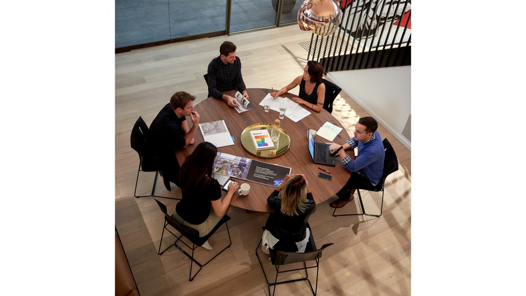 A group of people sitting around a table.