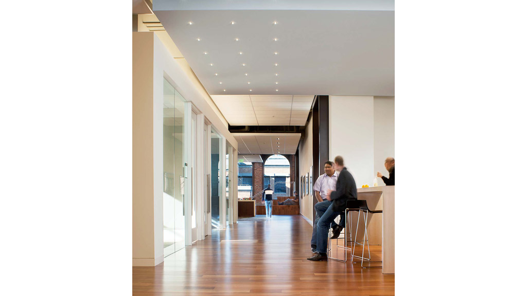 A group of people sitting at desks in a room.
