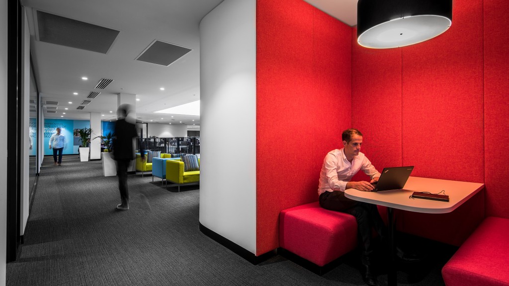 A person sitting at a table with a laptop.