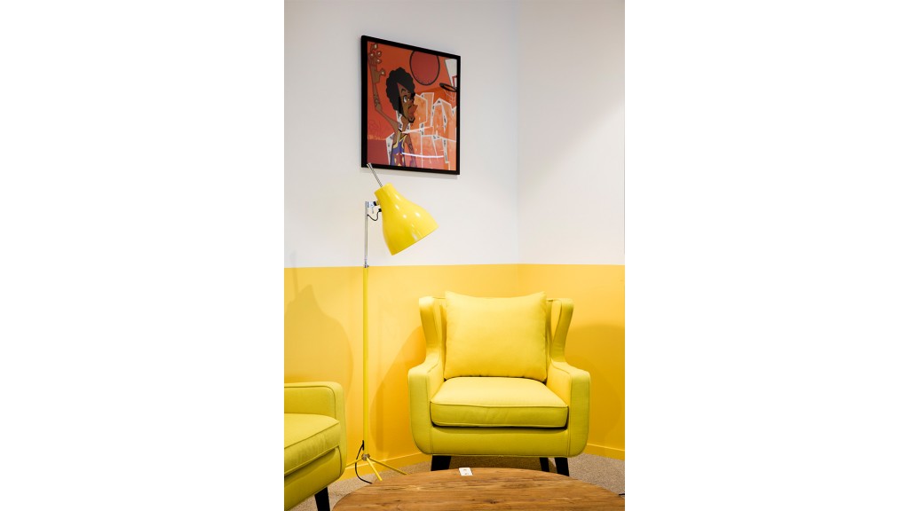 A yellow chair in a room.