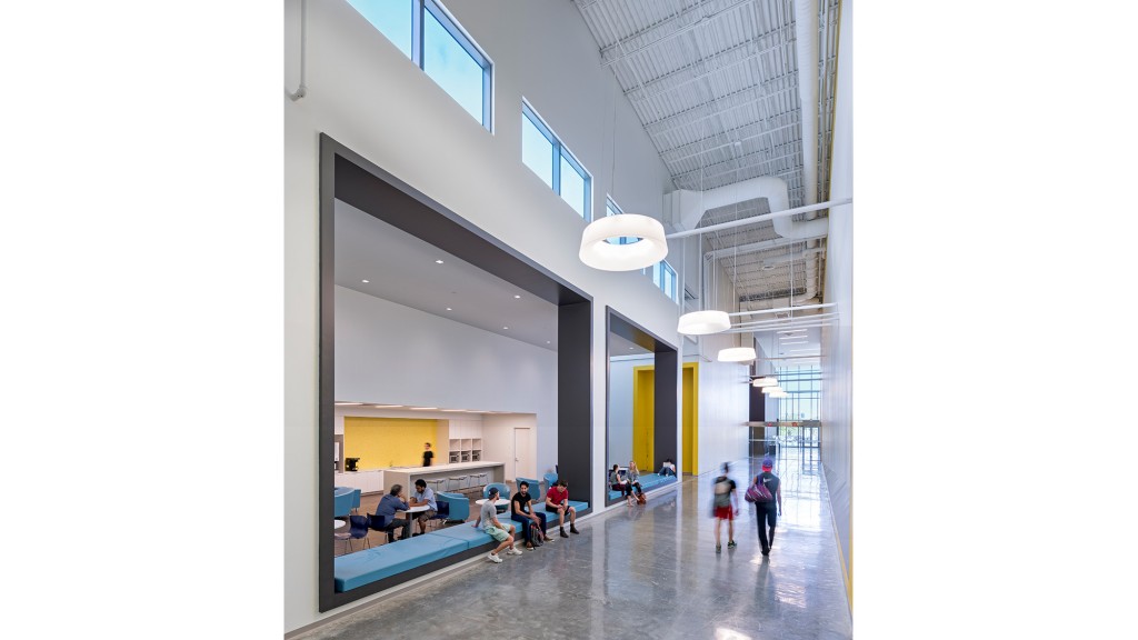 A group of people walking through a building.