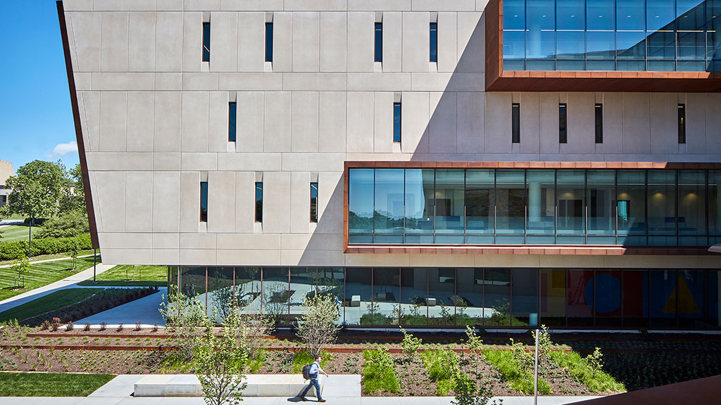 A building with a person walking in front of it.
