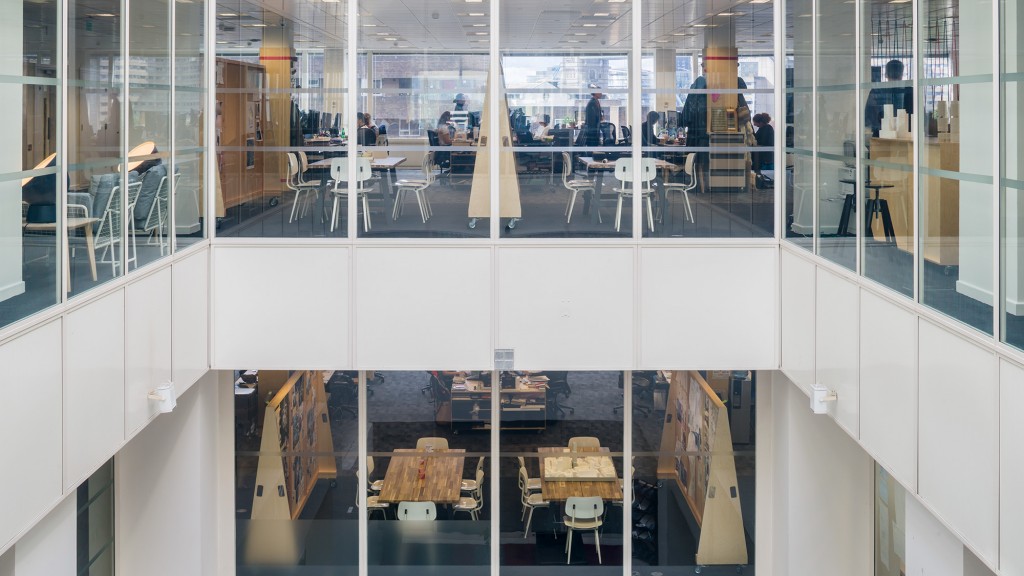 A room with glass walls and tables.