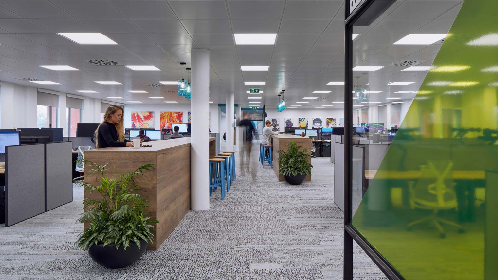 A person sitting at a desk in a large office.