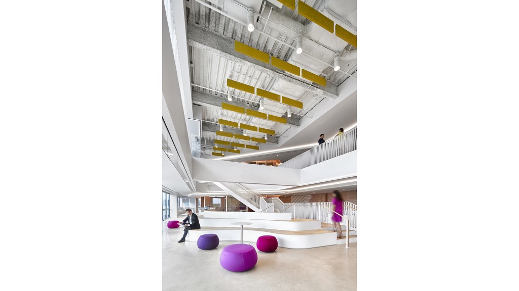 A few people walking in a building.