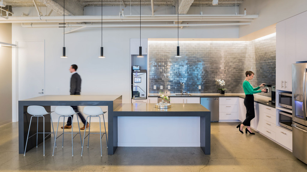 A couple of people in a kitchen.
