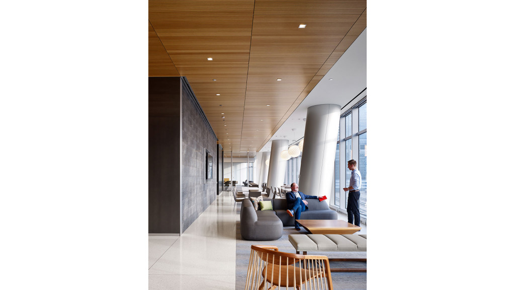 A man and a woman in a room with a couch and a table.