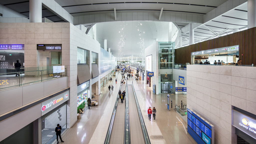 A train station with people walking.