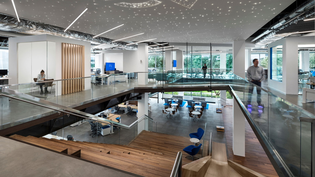 A large room with a glass floor and a few people in it.