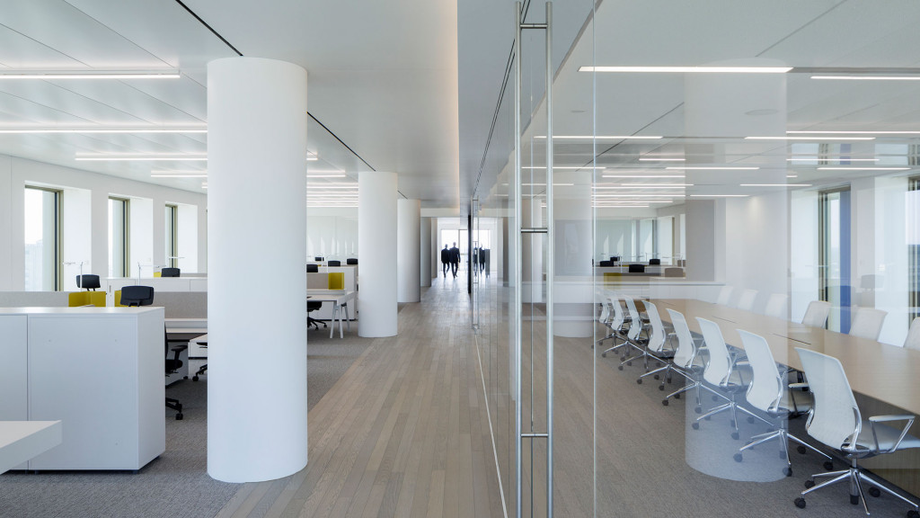 A room with white chairs and tables.