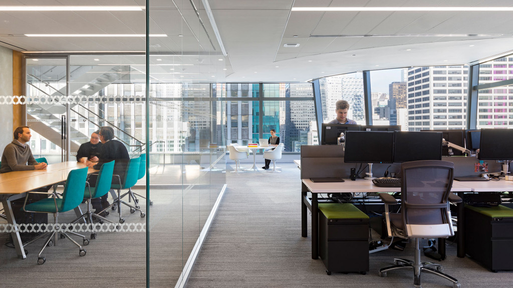 A group of people sitting at desks in an office.