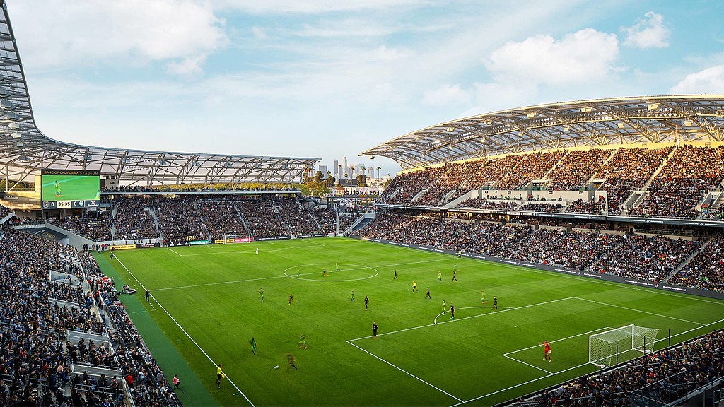 A football stadium with a field and players on it.