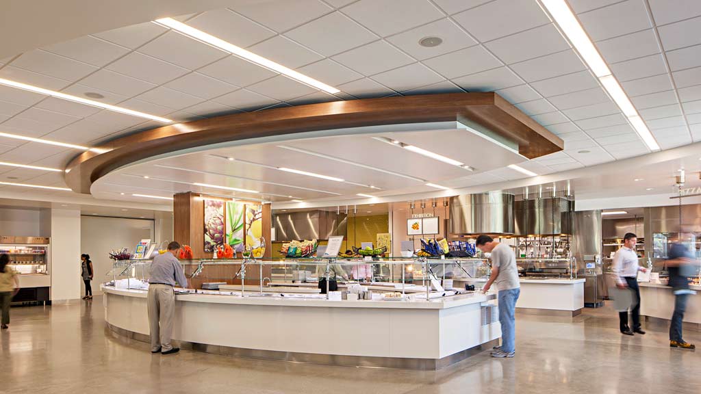 People in a large room with a large display of products.