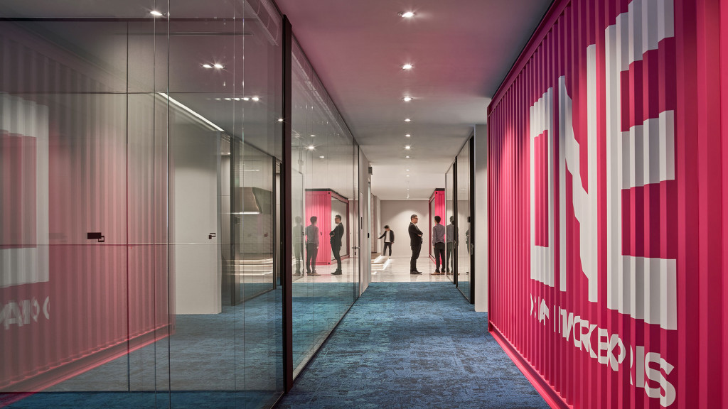 A group of people walking through a building.