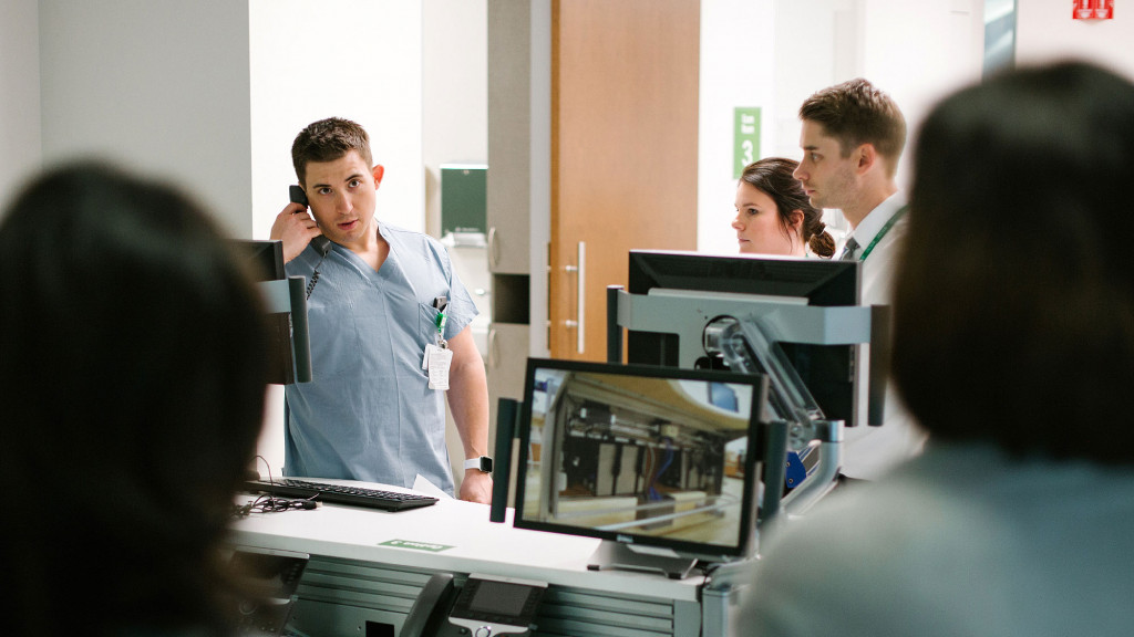 A group of people looking at a computer screen.