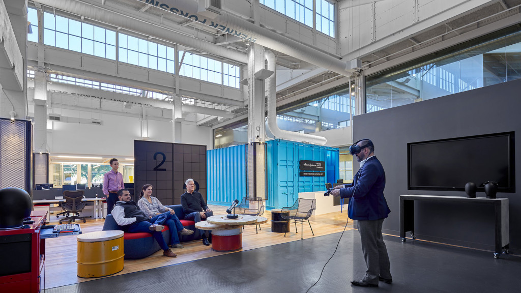 A man talking to a group of people in a room.