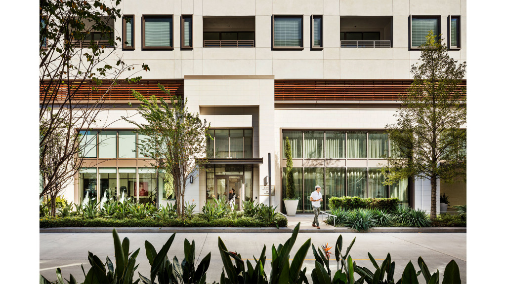 A person walking in front of a building.